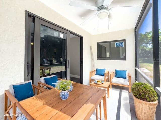 sunroom featuring a ceiling fan