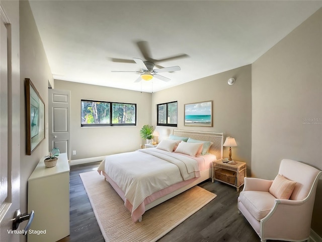 bedroom with baseboards, dark wood-style flooring, and ceiling fan