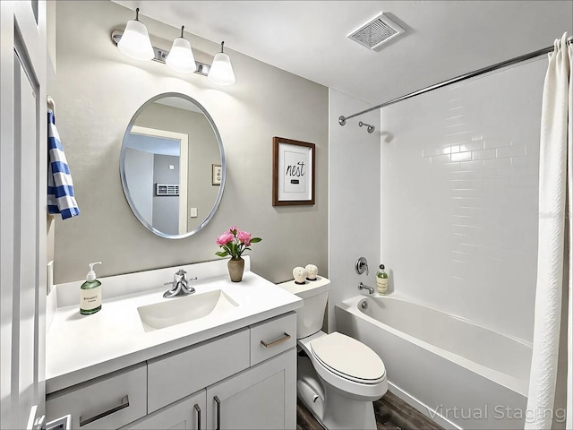 bathroom with visible vents,  shower combination, toilet, and vanity