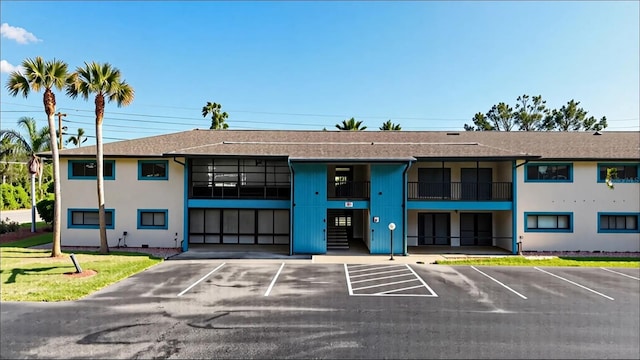 view of building exterior with uncovered parking