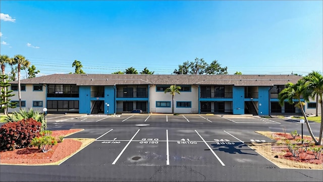 view of building exterior featuring uncovered parking