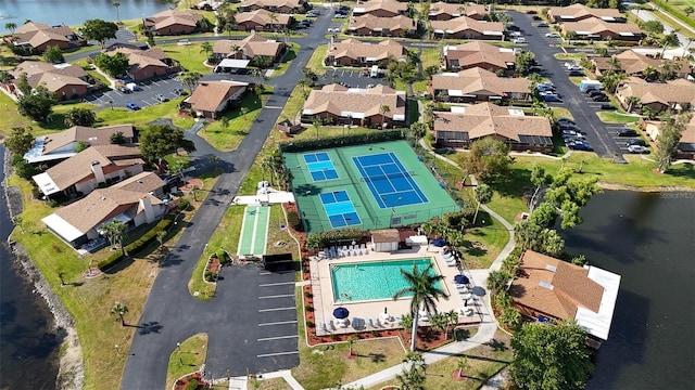 drone / aerial view with a water view and a residential view
