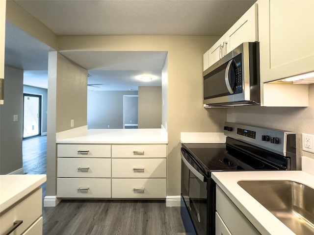 17426 Birchwood Ln Unit 3, Fort Myers, FL 33908 - kitchen featuring stainless steel appliances, dark wood finished floors, light countertops, and baseboards