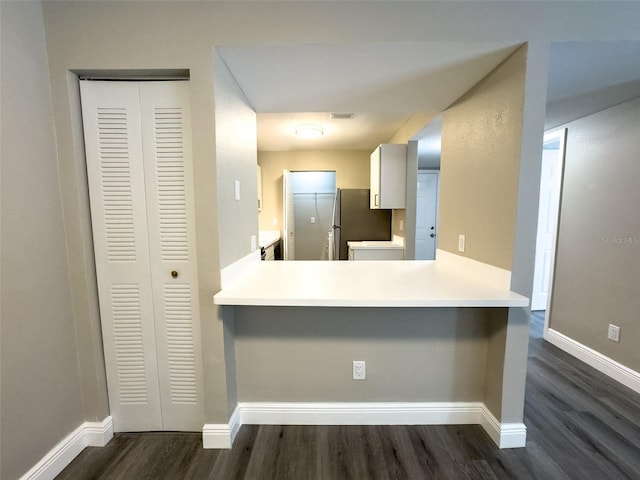 17426 Birchwood Ln Unit 3, Fort Myers, FL 33908 - kitchen with freestanding refrigerator, dark wood-style floors, baseboards, white cabinetry, and light countertops