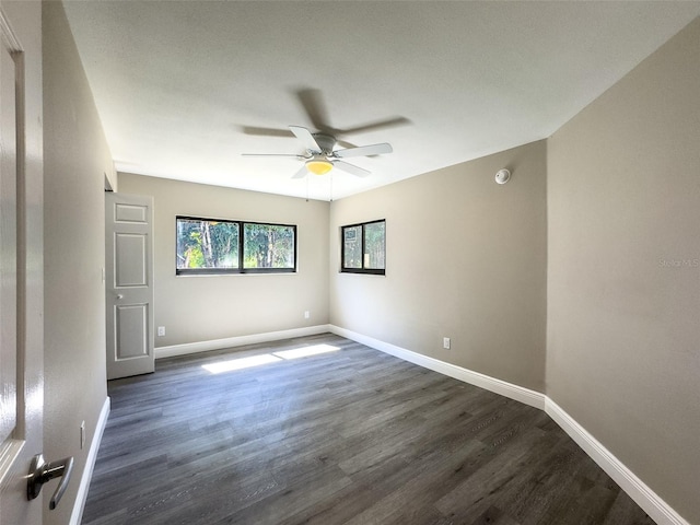 17426 Birchwood Ln Unit 3, Fort Myers, FL 33908 - unfurnished room featuring dark wood-style floors, a ceiling fan, baseboards, and a smoke detector
