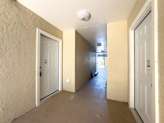 17426 Birchwood Ln Unit 3, Fort Myers, FL 33908 - hallway with a textured wall and finished concrete floors