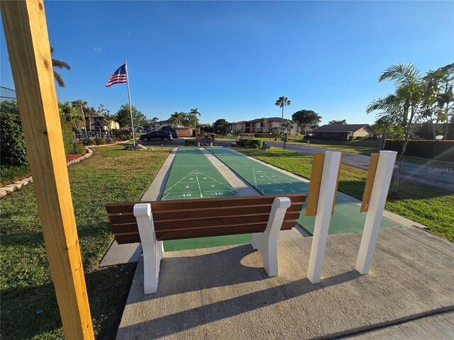 17426 Birchwood Ln Unit 3, Fort Myers, FL 33908 - surrounding community with shuffleboard, a yard, and a residential view