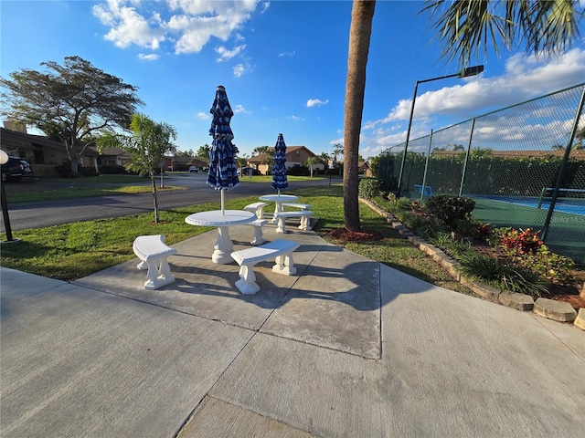 17426 Birchwood Ln Unit 3, Fort Myers, FL 33908 - view of community featuring a tennis court and fence