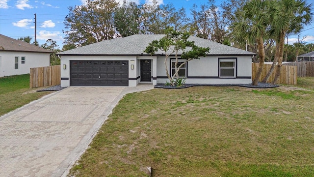 ranch-style house featuring a garage, a front yard, fence, and stucco siding