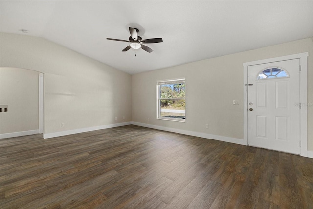 foyer entrance with lofted ceiling, ceiling fan, baseboards, and dark wood finished floors