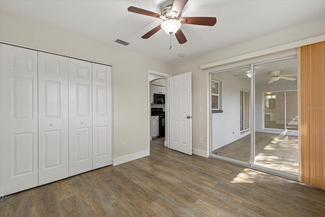 unfurnished bedroom featuring visible vents, ceiling fan, wood finished floors, access to outside, and baseboards