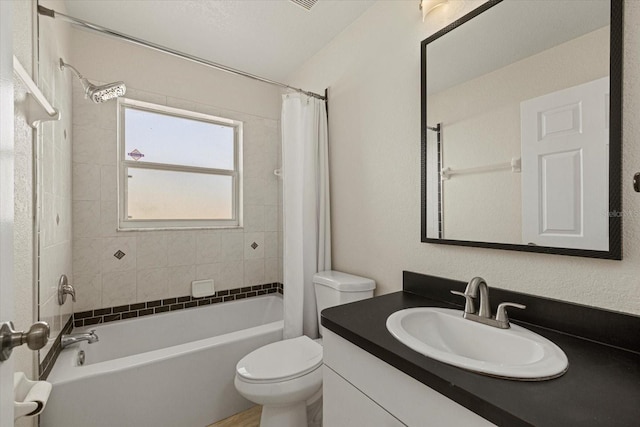 bathroom with shower / bath combination with curtain, vanity, and toilet