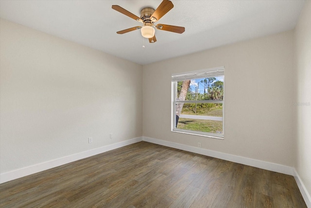 spare room featuring a ceiling fan, baseboards, and wood finished floors