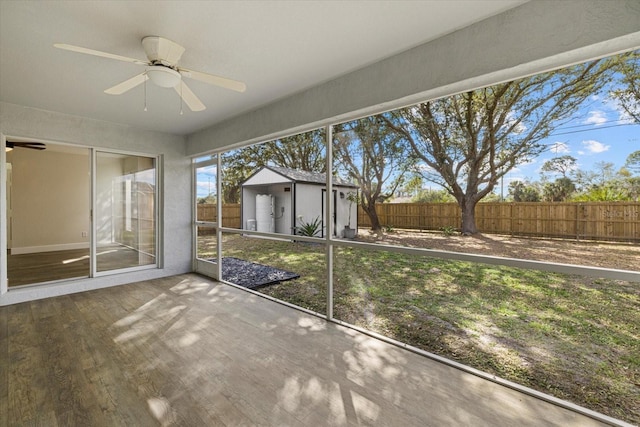 unfurnished sunroom featuring a ceiling fan