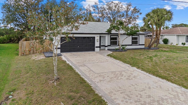 ranch-style house with driveway, an attached garage, fence, a front lawn, and stucco siding