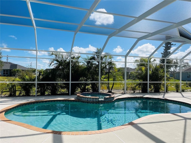 view of pool featuring glass enclosure, a patio, and a pool with connected hot tub