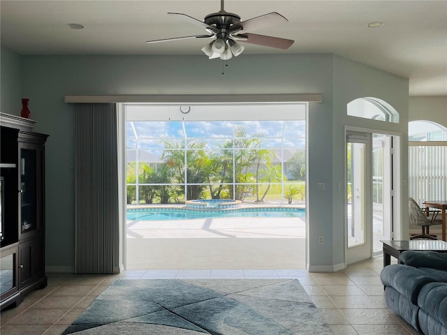 interior space with a healthy amount of sunlight, ceiling fan, and light tile patterned floors