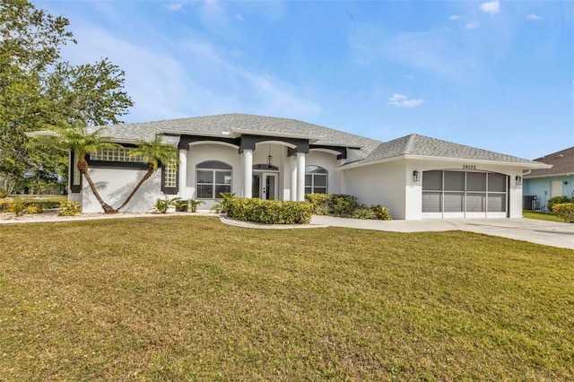 view of front of house with a garage, concrete driveway, roof with shingles, stucco siding, and a front lawn