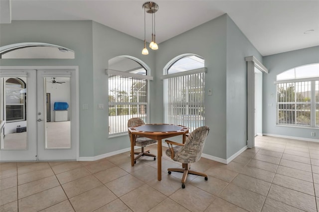 dining room featuring french doors, light tile patterned flooring, vaulted ceiling, and baseboards