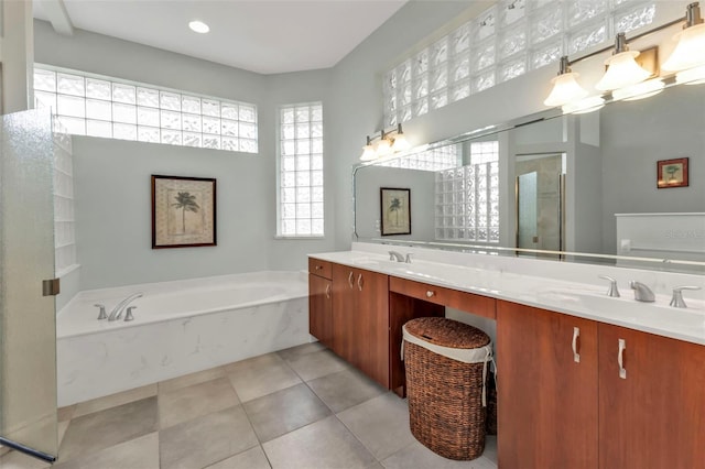 full bath featuring double vanity, a garden tub, a sink, and tile patterned floors