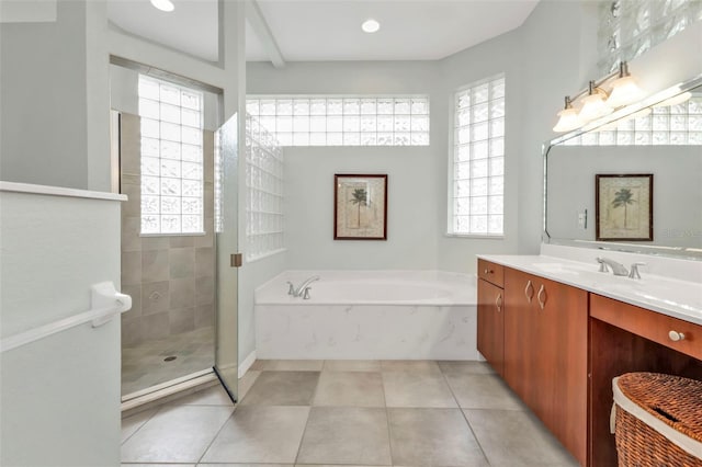 full bath with a stall shower, tile patterned floors, vanity, and a bath