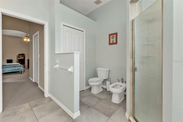 ensuite bathroom featuring visible vents, toilet, a stall shower, a bidet, and tile patterned flooring