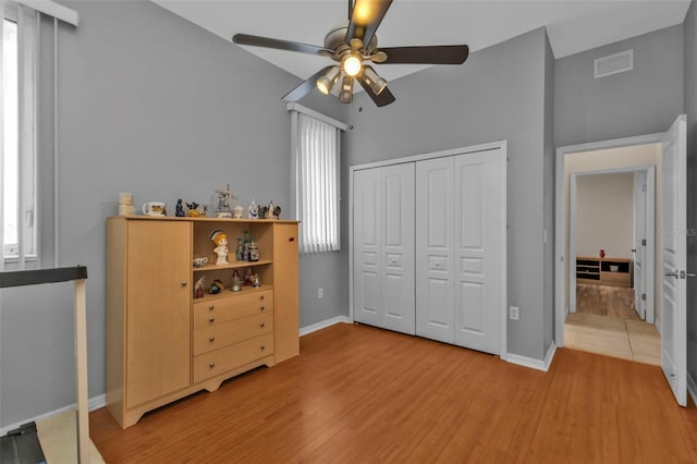 bedroom featuring baseboards, a closet, visible vents, and light wood-style floors