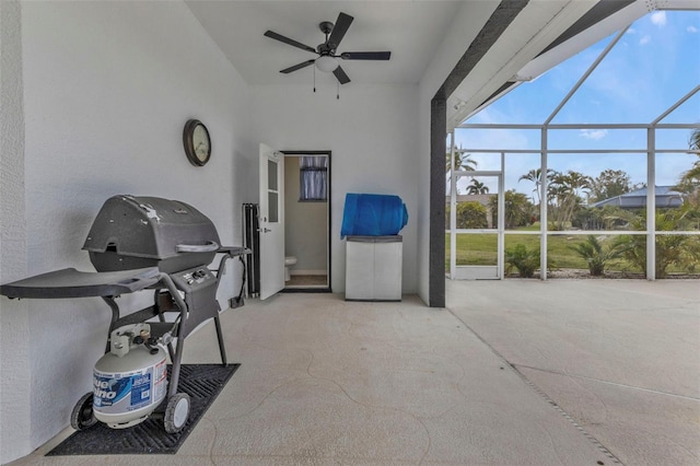 view of patio / terrace with a lanai, ceiling fan, and area for grilling