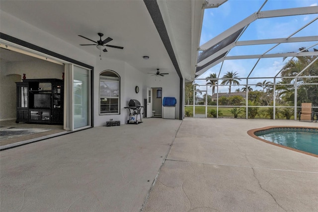 outdoor pool with ceiling fan, a patio area, and a lanai