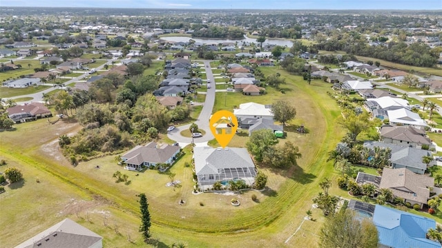 birds eye view of property with a water view and a residential view