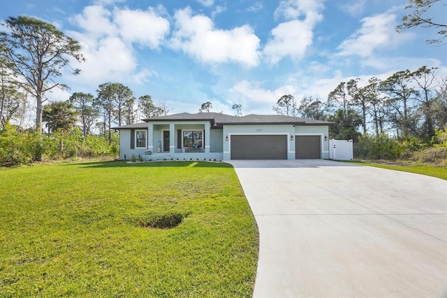 view of front facade featuring a garage, concrete driveway, a front lawn, and stucco siding