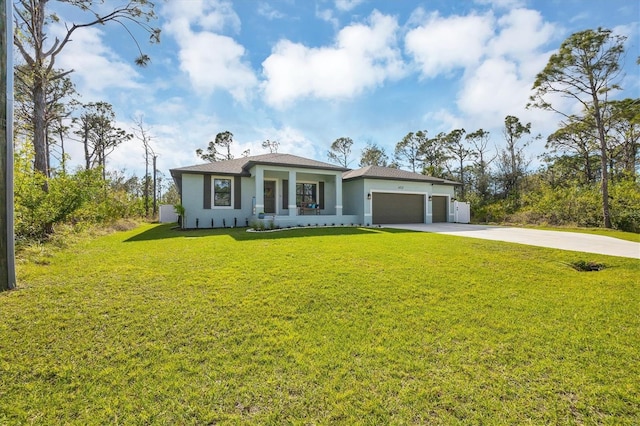 view of front facade featuring a garage, driveway, a front yard, and stucco siding