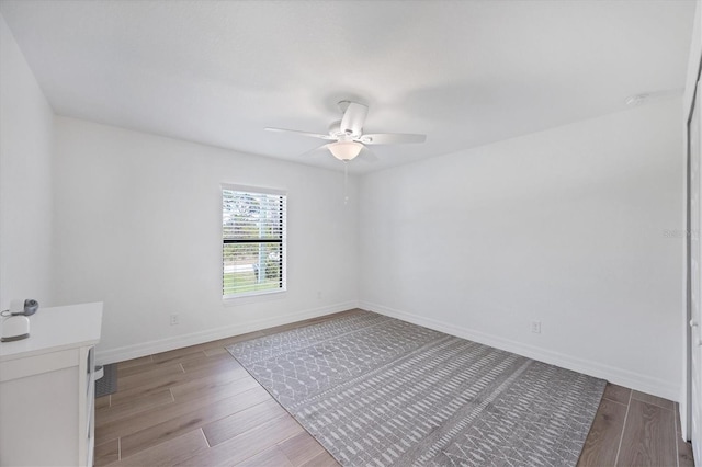 14325 Mcfarland Ave, Port Charlotte, FL 33981 - spare room with a ceiling fan, wood finished floors, and baseboards