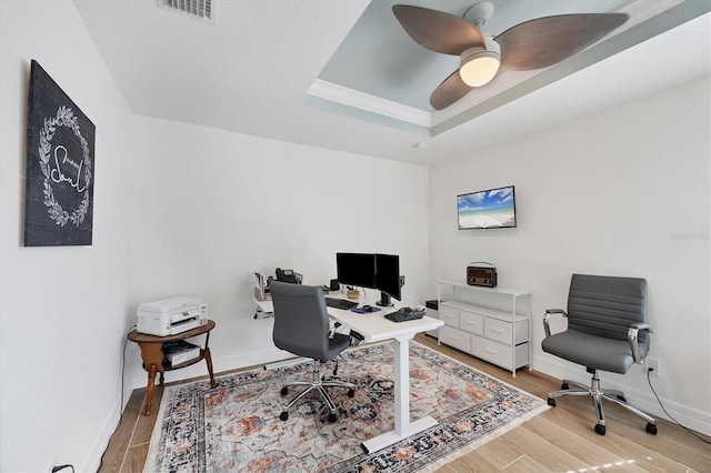 14325 Mcfarland Ave, Port Charlotte, FL 33981 - office area with light wood-style flooring, a tray ceiling, ceiling fan, and baseboards
