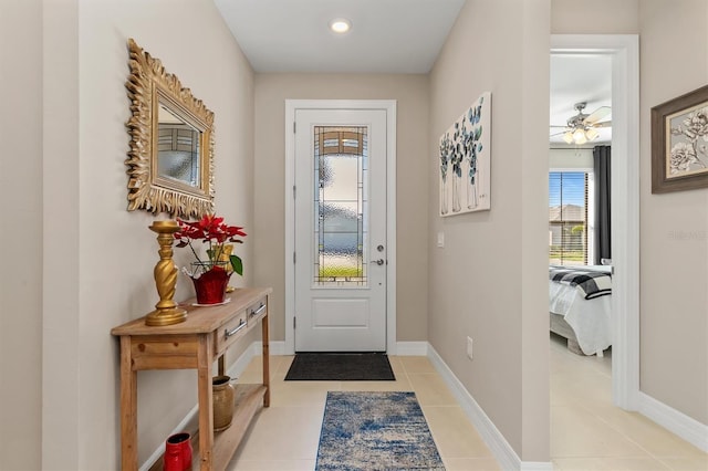 doorway to outside with light tile patterned floors and baseboards