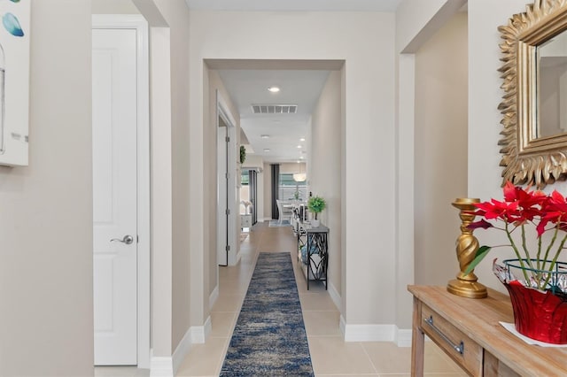 hallway with recessed lighting, visible vents, baseboards, and light tile patterned flooring