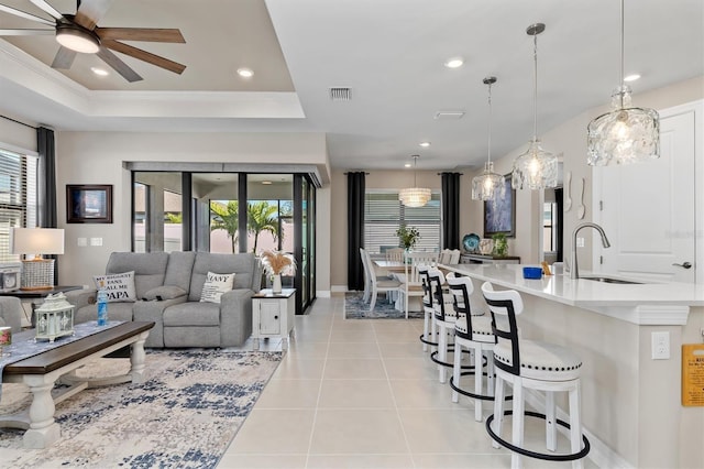 living room featuring recessed lighting, a raised ceiling, visible vents, and light tile patterned floors