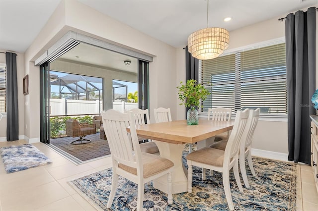 tiled dining room with recessed lighting and baseboards