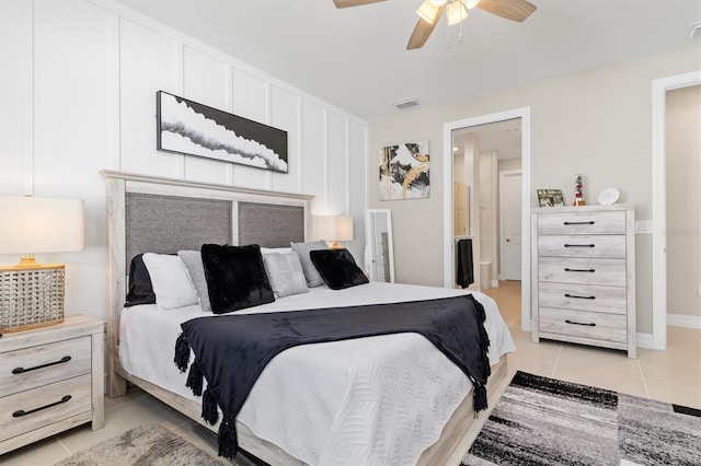 bedroom with a ceiling fan, visible vents, and light tile patterned floors