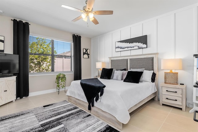 bedroom featuring a ceiling fan, baseboards, and light tile patterned floors