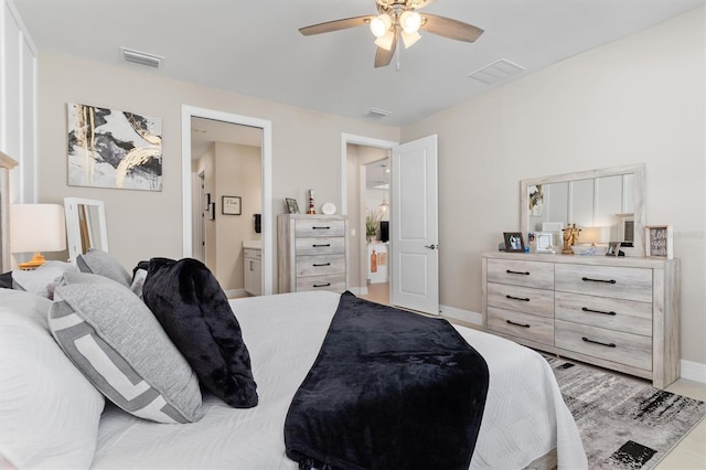 bedroom featuring visible vents, ceiling fan, baseboards, and ensuite bathroom