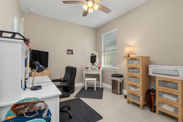 home office featuring a ceiling fan, baseboards, and light tile patterned floors