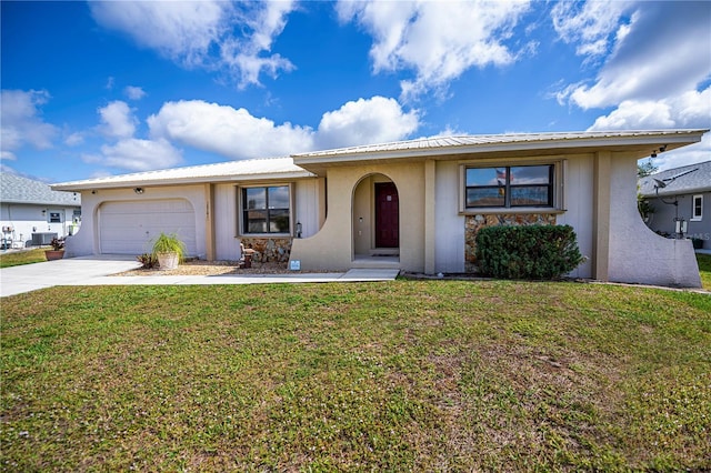 single story home with an attached garage, a front lawn, concrete driveway, and stucco siding