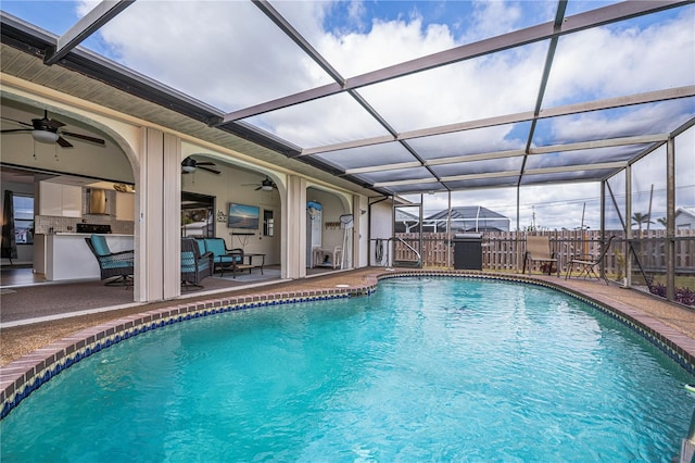 view of swimming pool featuring glass enclosure, fence, a fenced in pool, and a patio