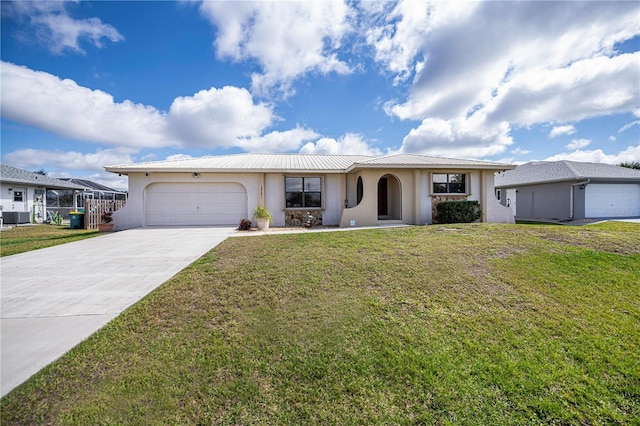 single story home with an attached garage, a front yard, and stucco siding