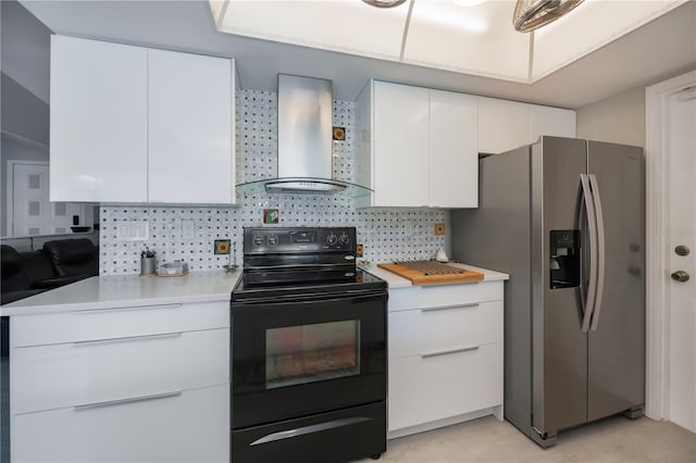 kitchen featuring light countertops, black electric range oven, backsplash, wall chimney range hood, and stainless steel fridge