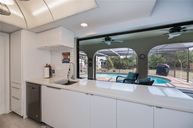 kitchen with dishwasher, plenty of natural light, a sink, and a sunroom