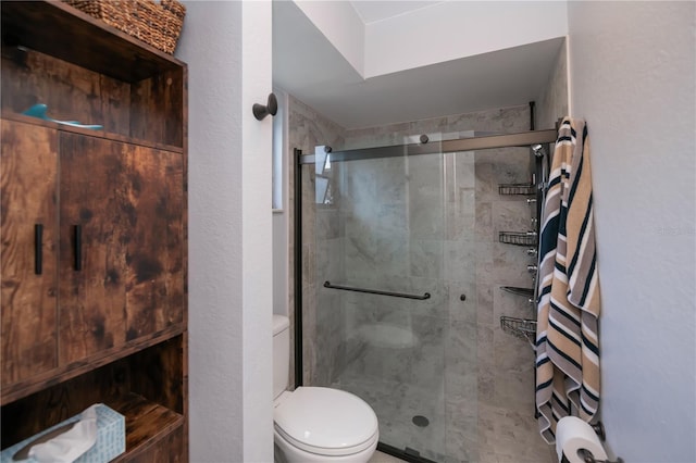 bathroom featuring a stall shower and toilet