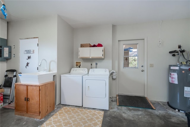 laundry area featuring a sink, water heater, cabinet space, electric panel, and washer and clothes dryer