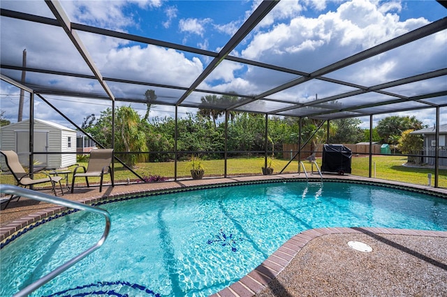 pool featuring a storage shed, a lawn, a lanai, an outdoor structure, and a patio area